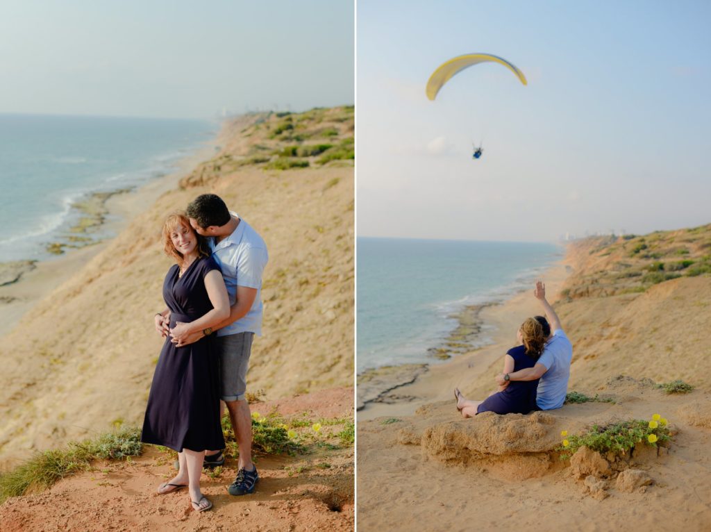 two photos of couple hugging and looking and parasailing person in beach engagement photoshoot