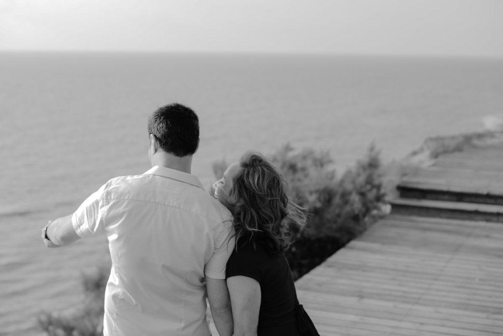 black and white photo of couple on beach engagement photoshoot