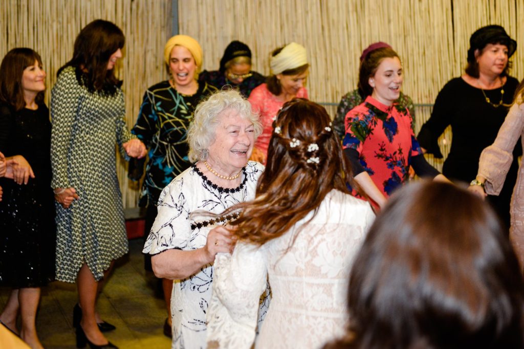 large group of family dancing at wedding party 