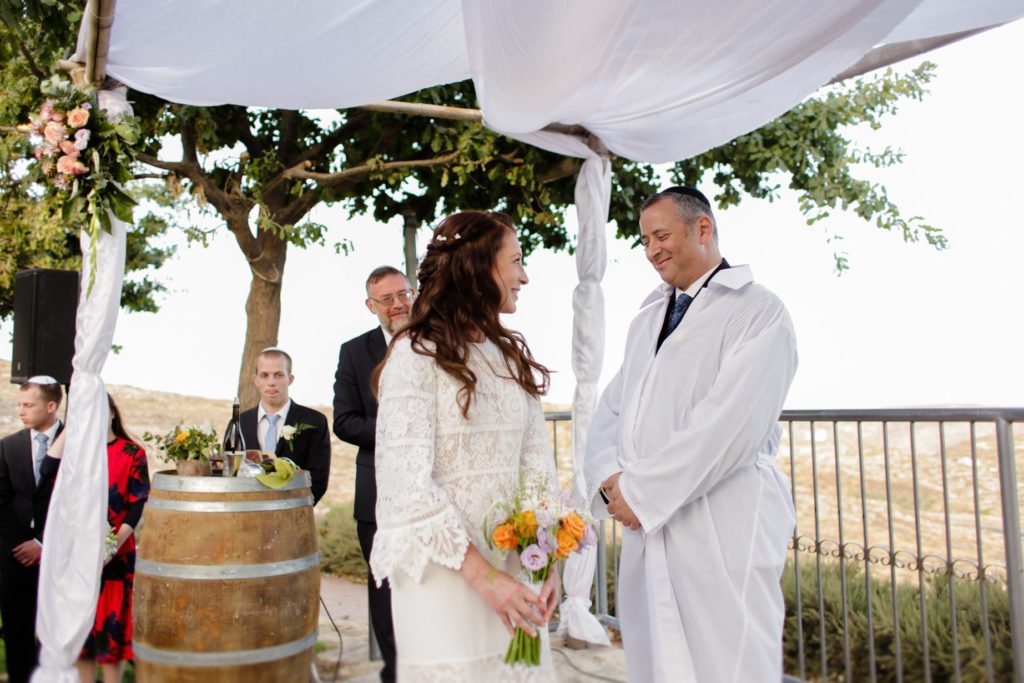 wedding photo of bride with bouquet at altar