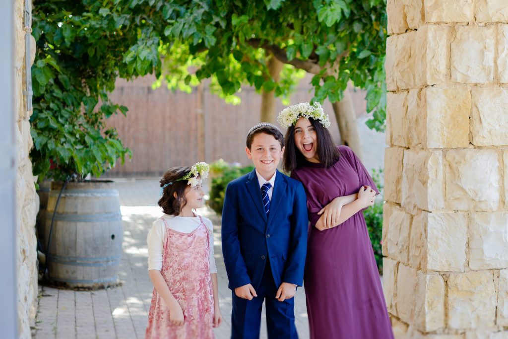 three children in desert wedding photoshoot in brick doorway 