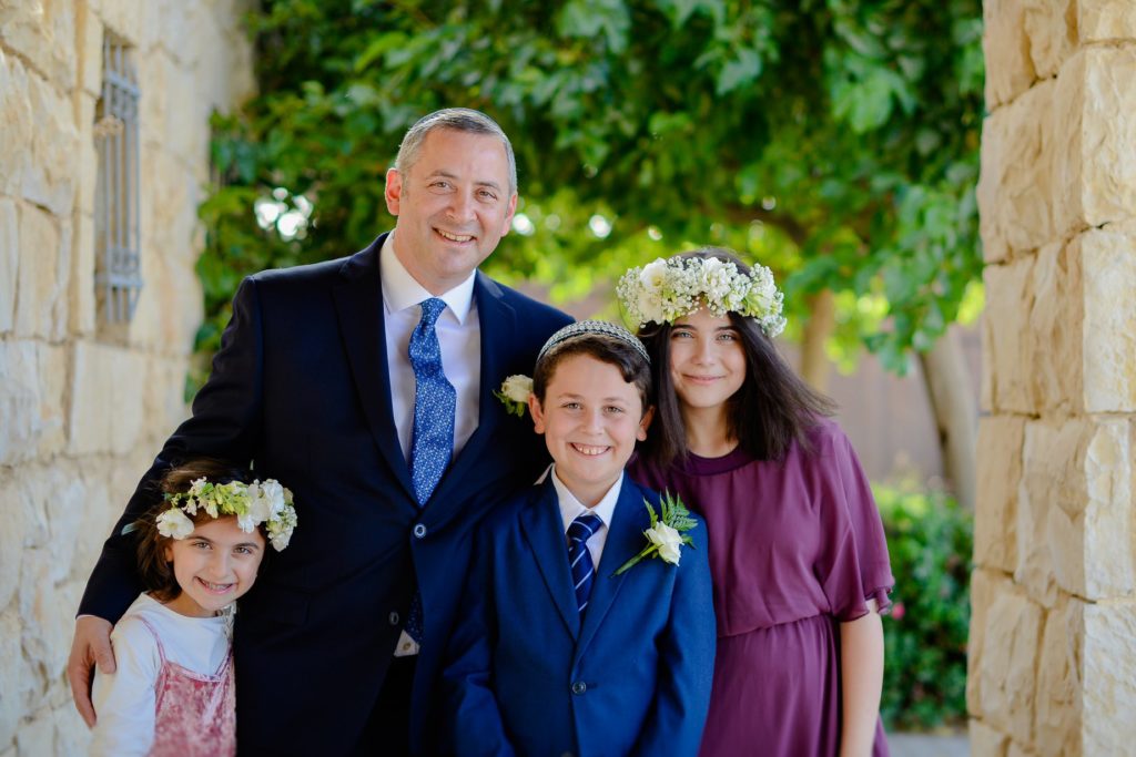 family photo with father and three young children at desert wedding photoshoot