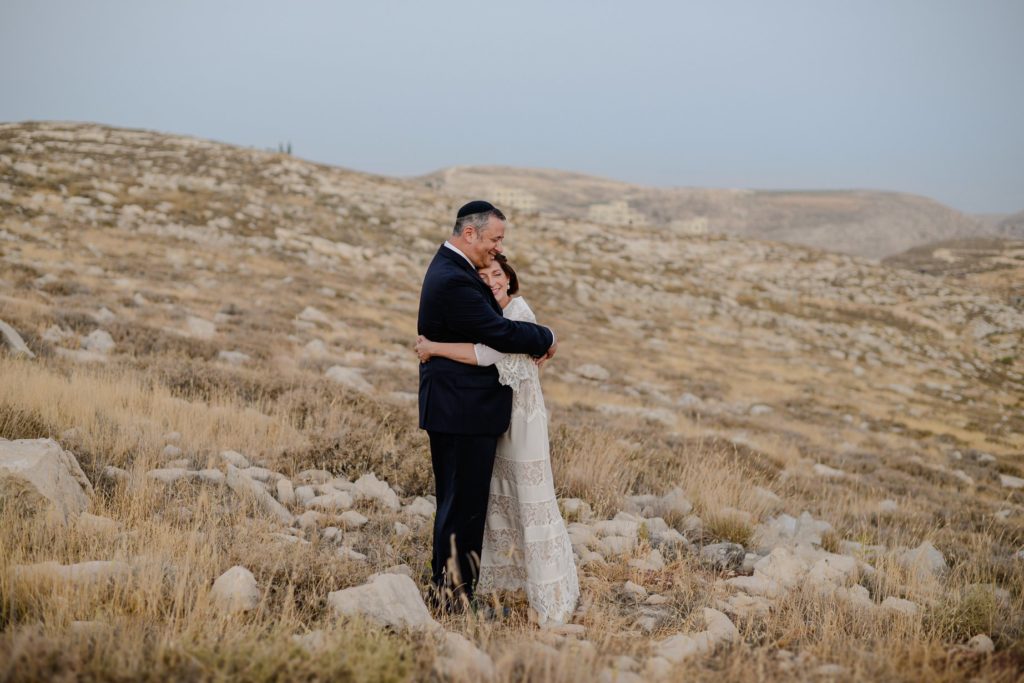 bride and groom hugging at outdoor wedding photography session