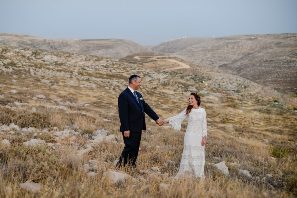 bride and groom standing in desert wedding photography session