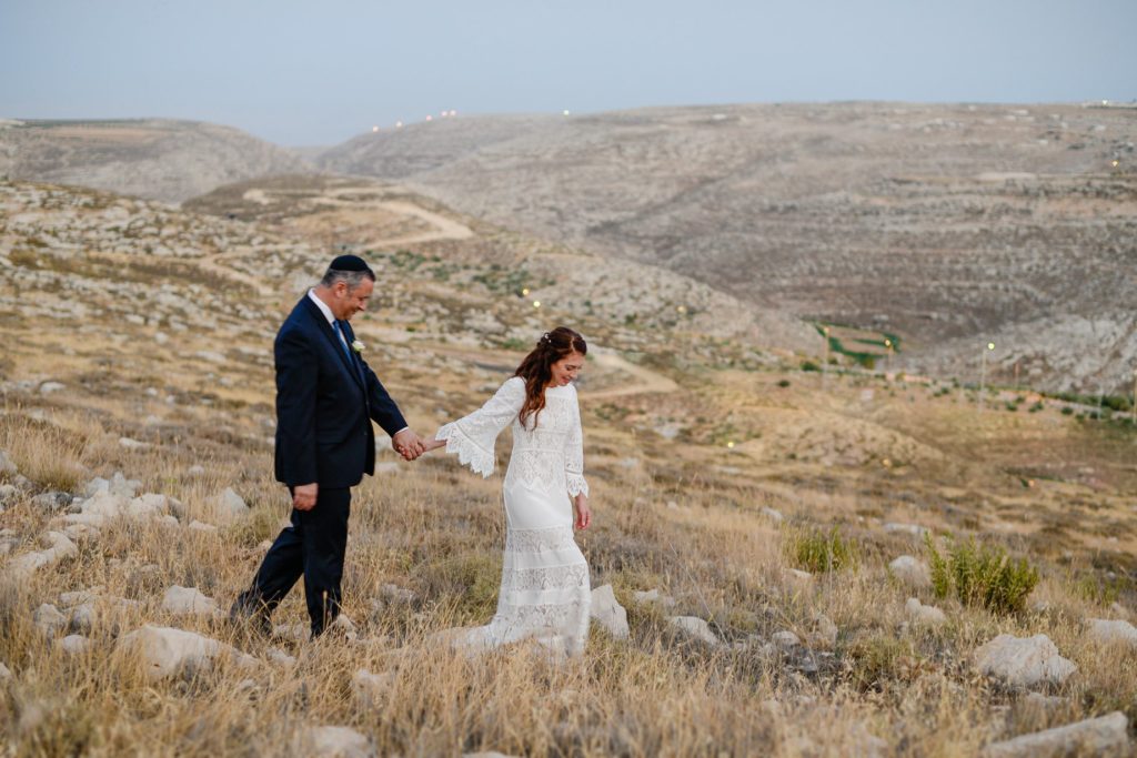 bride and groom posing outside at desert wedding photoshoot