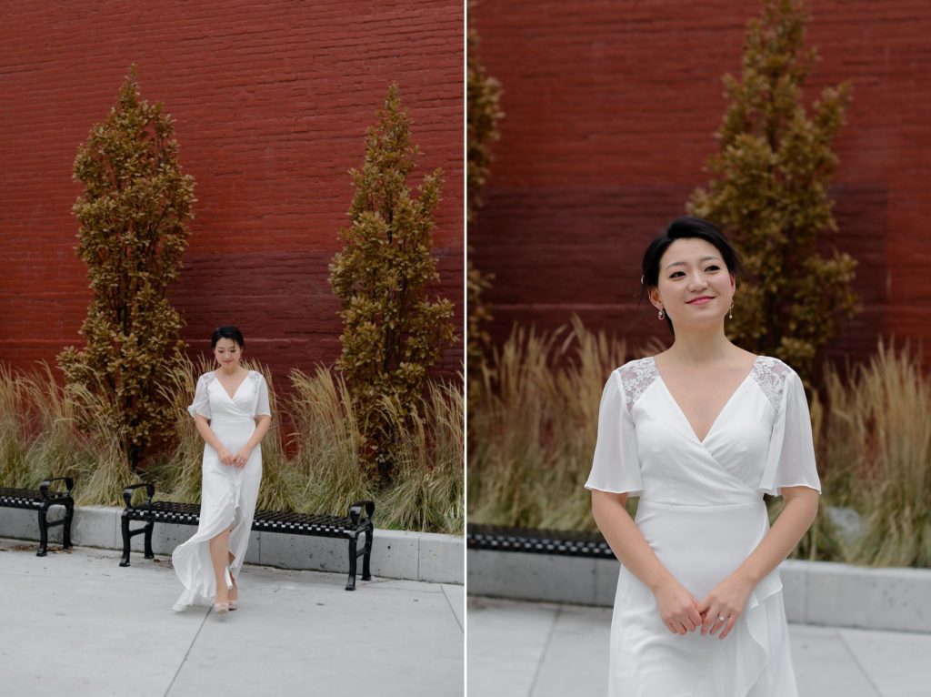 smiling bride against red brick wall for wedding photoshoot