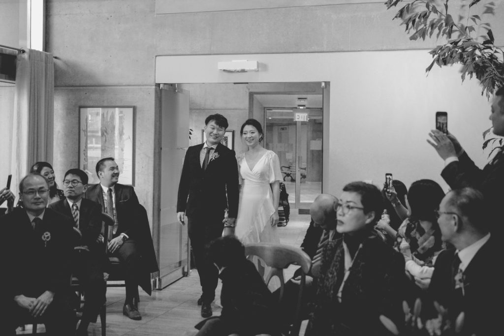 black and white photo of couple entering wedding chapel