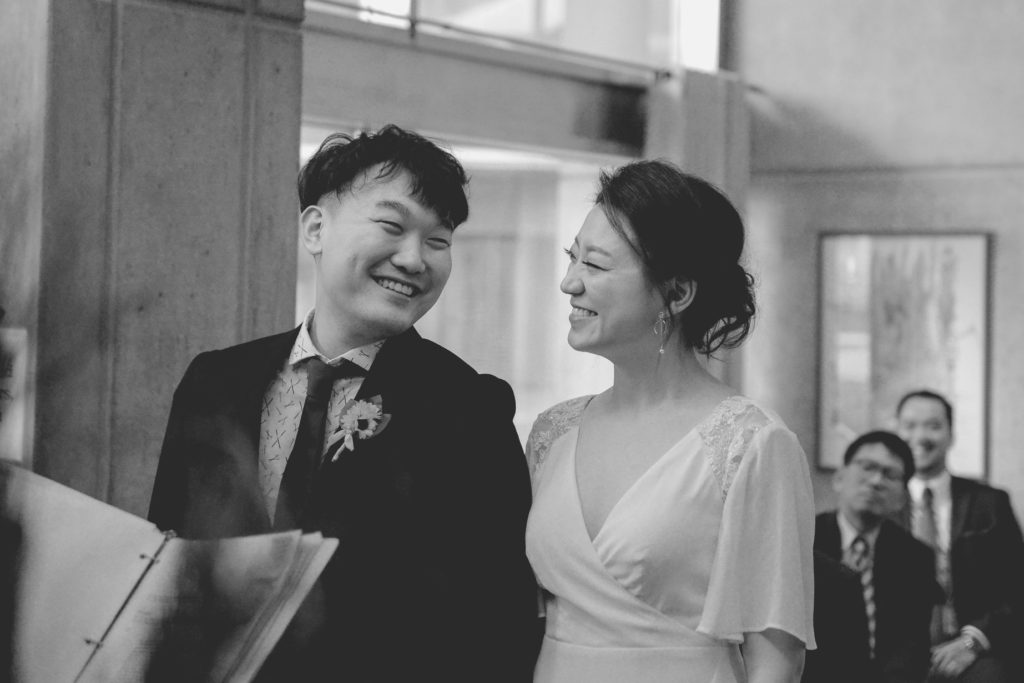 black and white photo of smiling couple at their wedding photoshoot