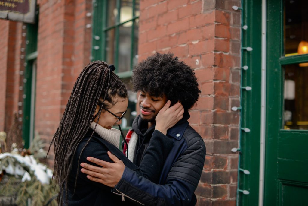 couple touching outside for engagement photography session