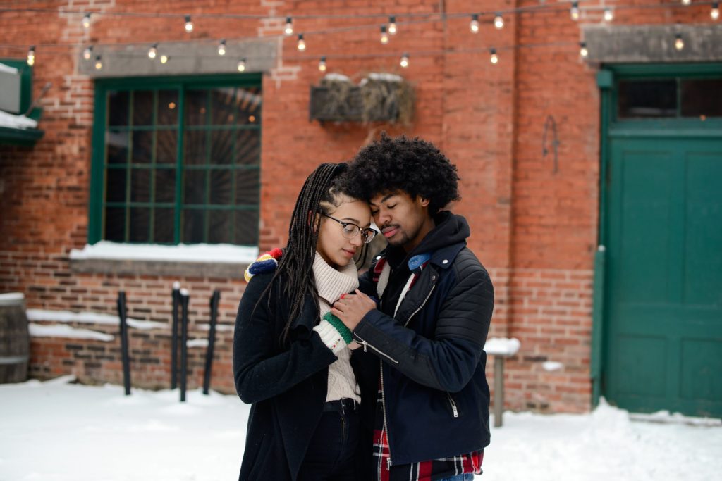 couple posing and touching outside for engagement photography session