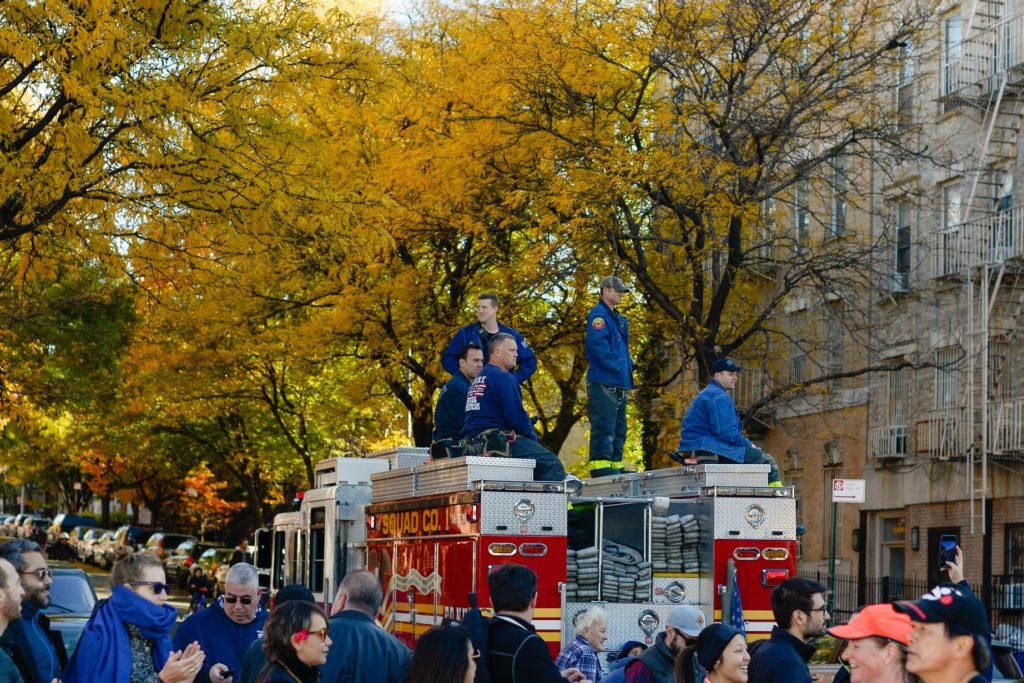 Brooklyn fire fighters sitting on top of truck watching the Brooklyn marathon - Lauren Newman Photography