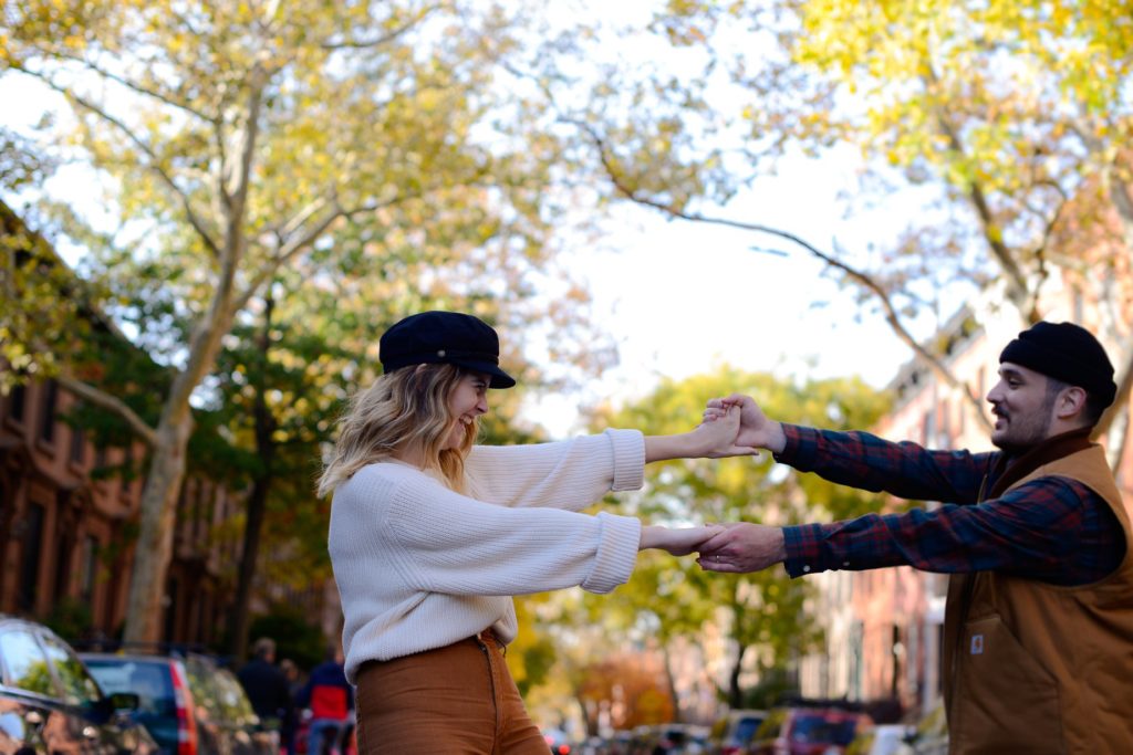 dancing couple in new york city street at engagement photoshoot