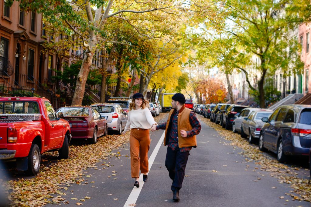 couple walking down the street in new york city at engagement photography session