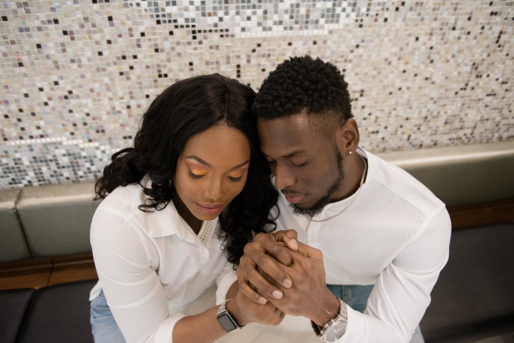 Close up photo of Jamaican couple holding hands